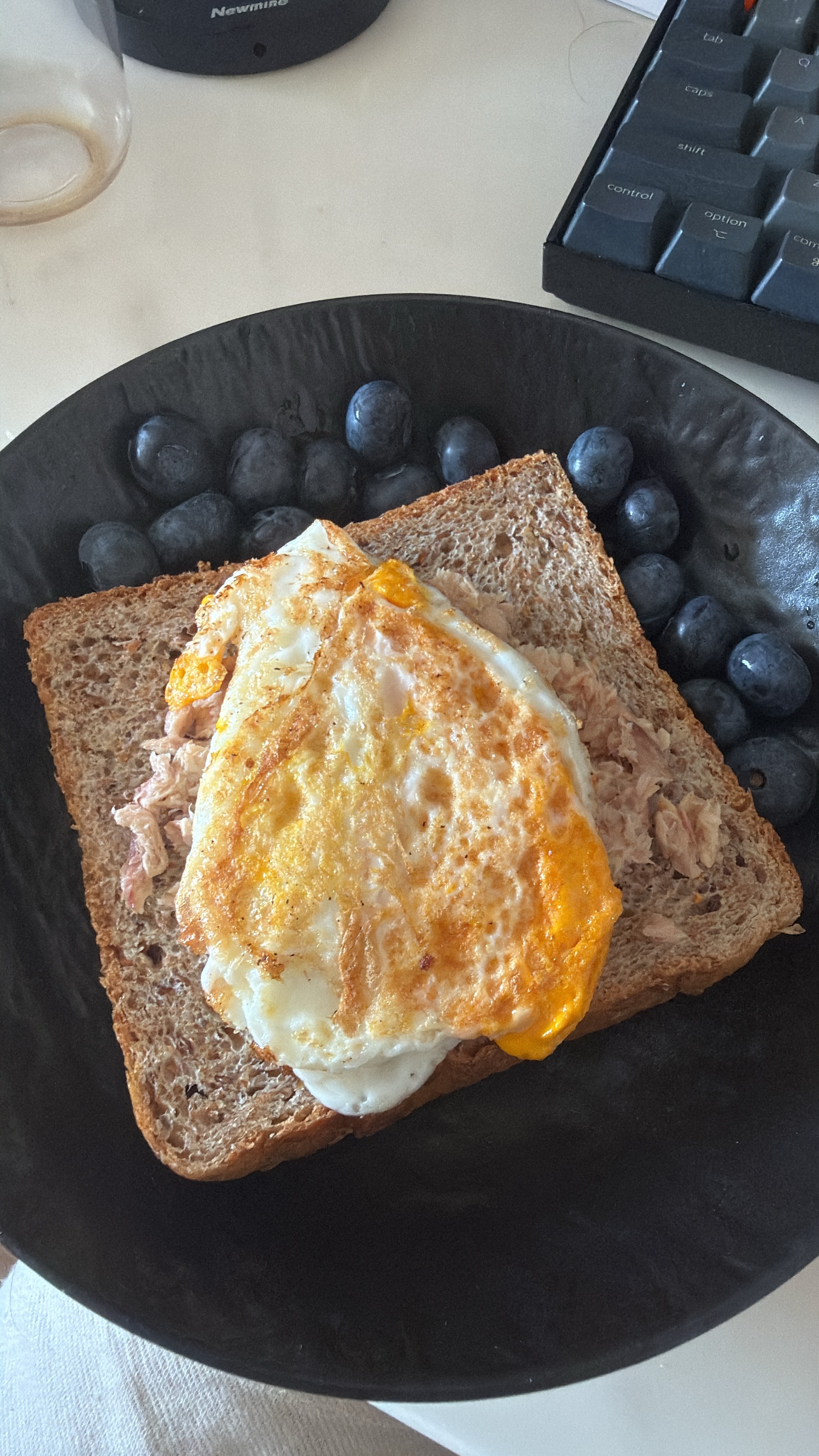 Source image for Fried Egg Yolk Bursting Over Tuna Toast on Desk